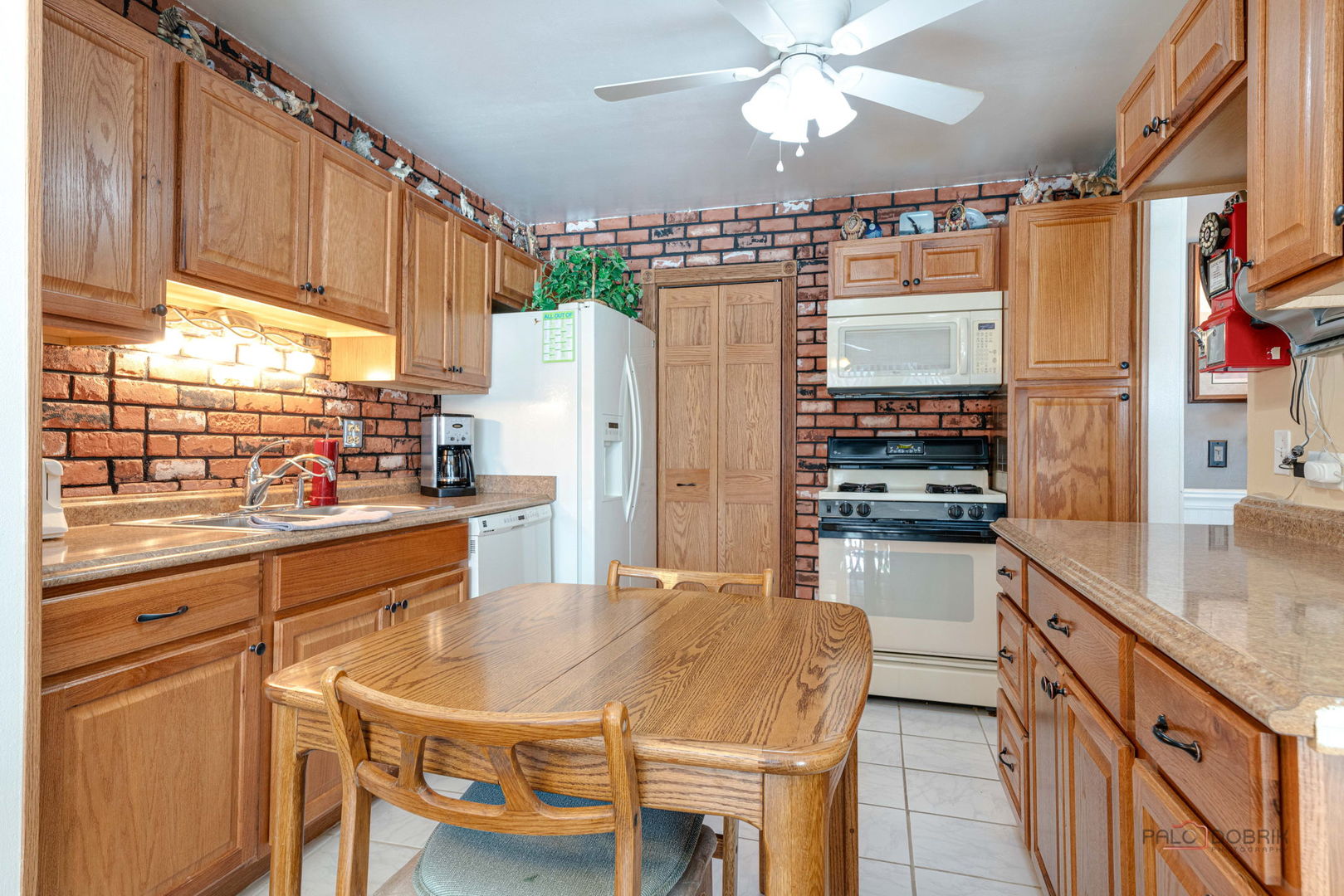 1157 Middlebury Lane, Unit B1 Wheeling, IL 60090 - Photo 9 of 18 a kitchen with stainless steel appliances a stove a refrigerator and a kitchen island