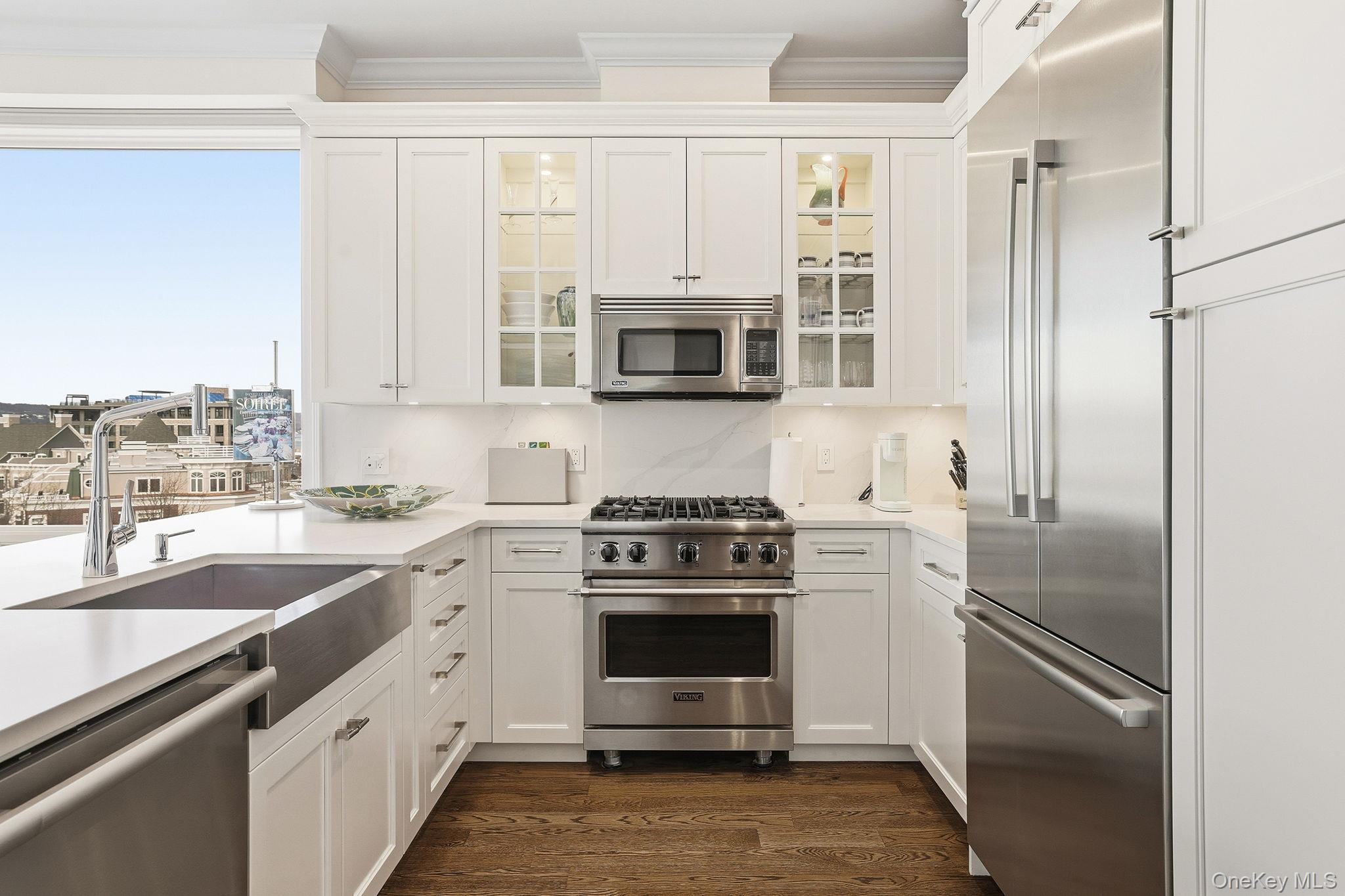 11 River Street, Unit 415 Sleepy Hollow, NY 10591 - Photo 11 of 37 a kitchen with cabinets stainless steel appliances and a counter space