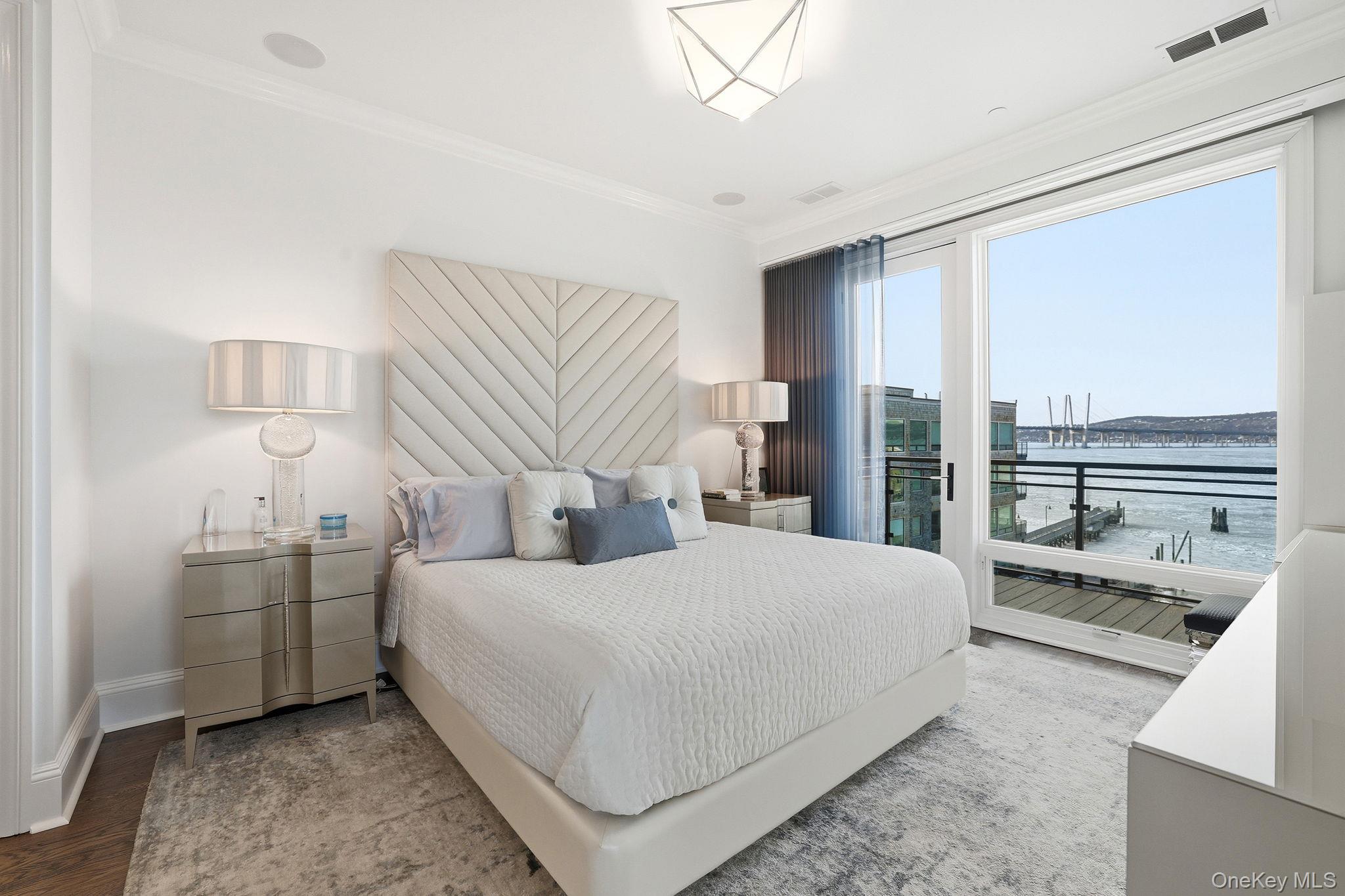 11 River Street, Unit 415 Sleepy Hollow, NY 10591 - Photo 18 of 37 a bedroom with a bed and a large window