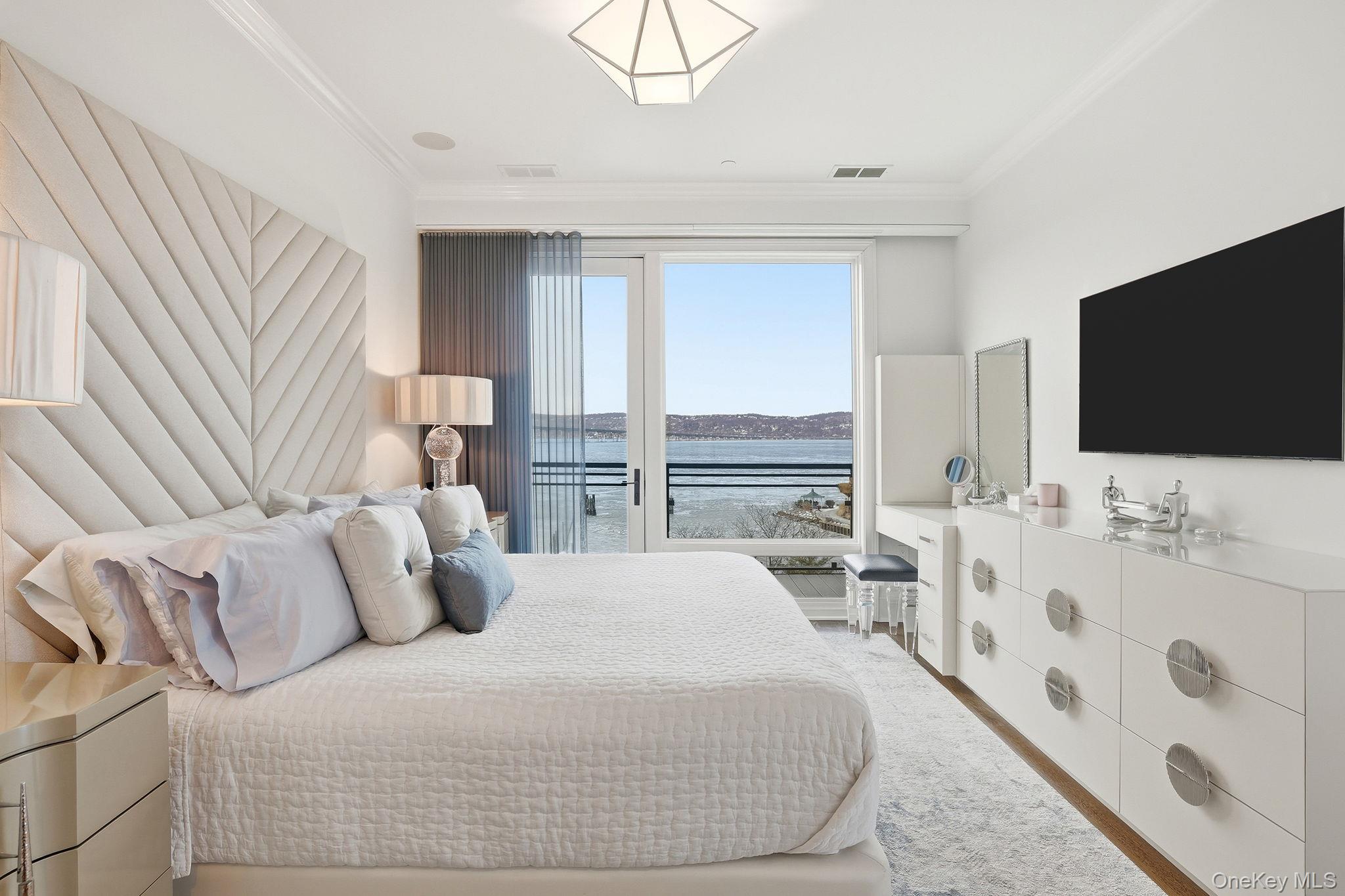 11 River Street, Unit 415 Sleepy Hollow, NY 10591 - Photo 19 of 37 a bedroom with a large bed and a flat screen tv