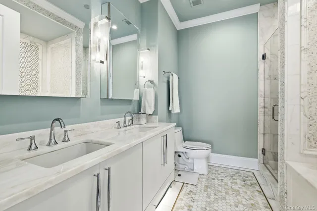 a bathroom with a sink a toilet and shower