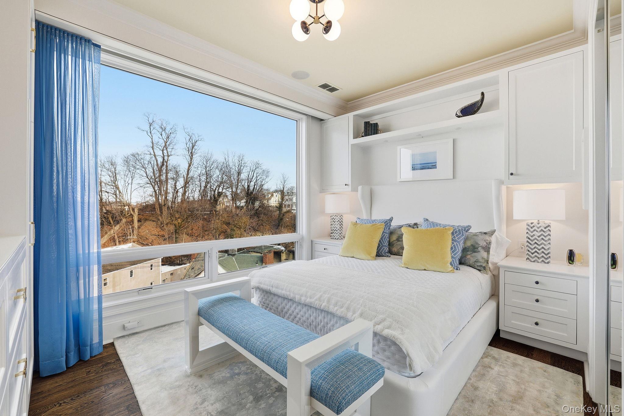 11 River Street, Unit 415 Sleepy Hollow, NY 10591 - Photo 24 of 37 a bedroom with a bed and a large window with balcony view