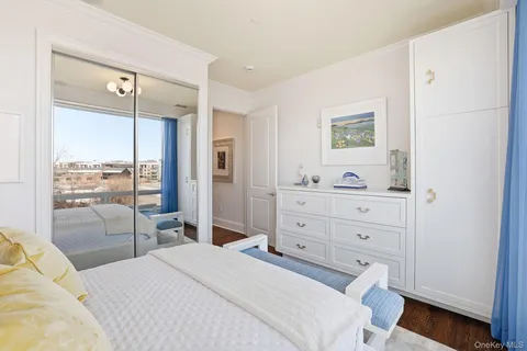 a bedroom with a bed a window and a mirror