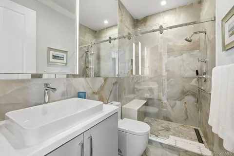 a bathroom with a sink toilet and shower