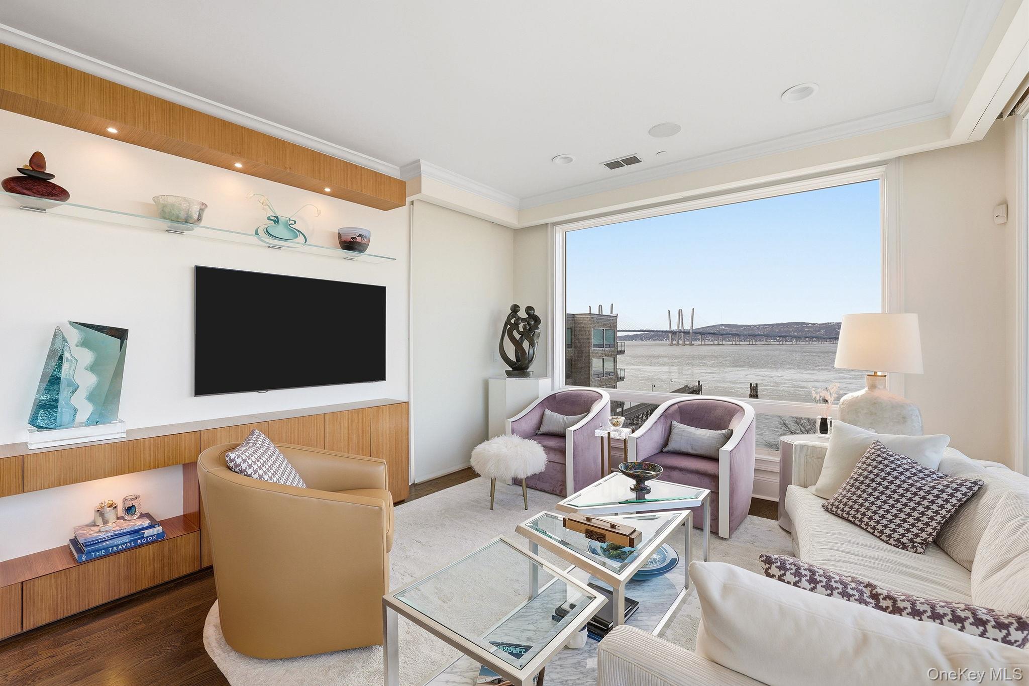 11 River Street, Unit 415 Sleepy Hollow, NY 10591 - Photo 4 of 37 a living room with furniture and a flat screen tv