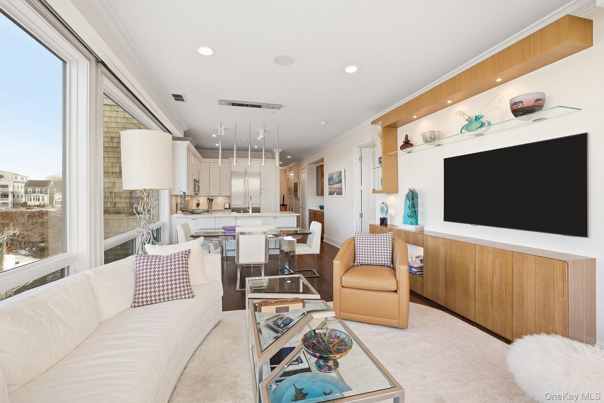 11 River Street, Unit 415 Sleepy Hollow, NY 10591 - Photo 7 of 37 a living room with furniture and a flat screen tv