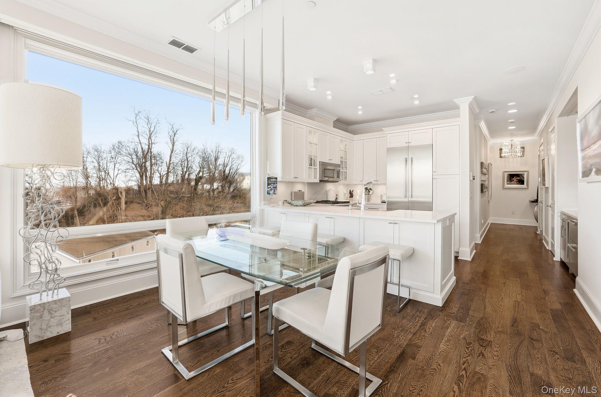 11 River Street, Unit 415 Sleepy Hollow, NY 10591 - Photo 8 of 37 a dining hall with stainless steel appliances kitchen island granite countertop a refrigerator and cabinets