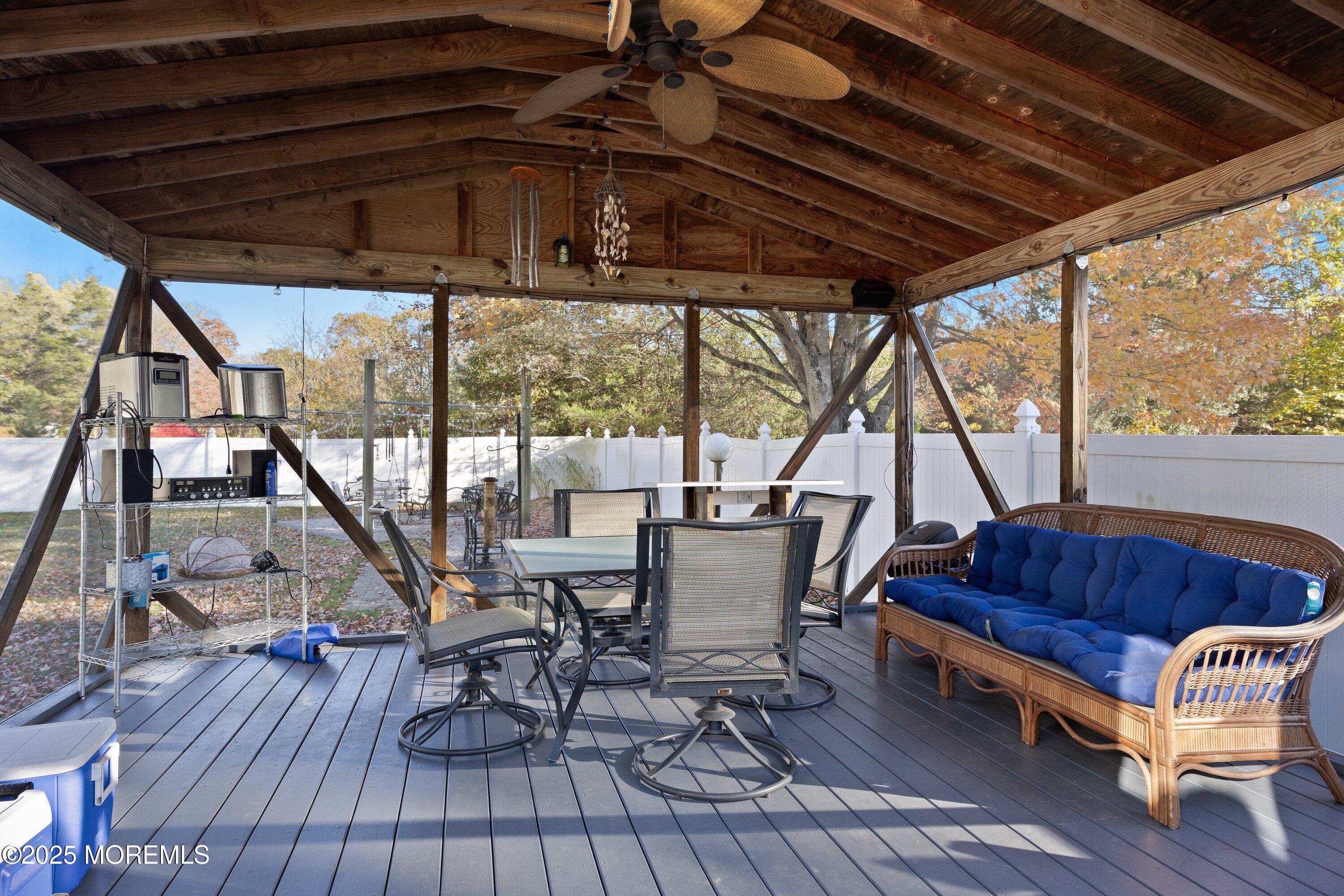 380 East Millstream Road Cream Ridge, NJ 08514 - Photo 36 of 52 a roof deck with table and chairs and wooden floor