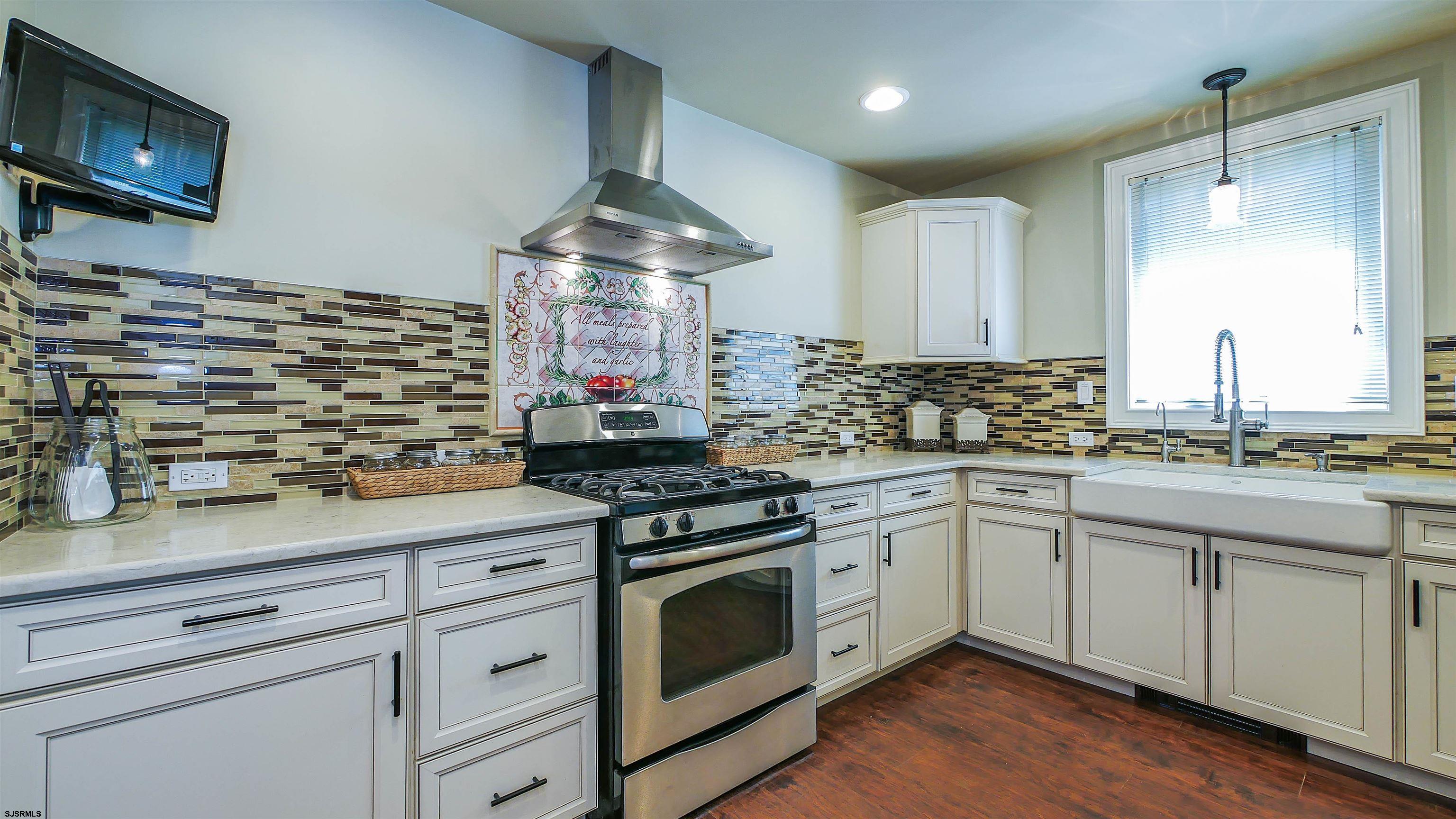 810 East Moss Mill Road Leeds Point, NJ 08205 - Photo 11 of 36 a kitchen with stainless steel appliances a stove and a sink