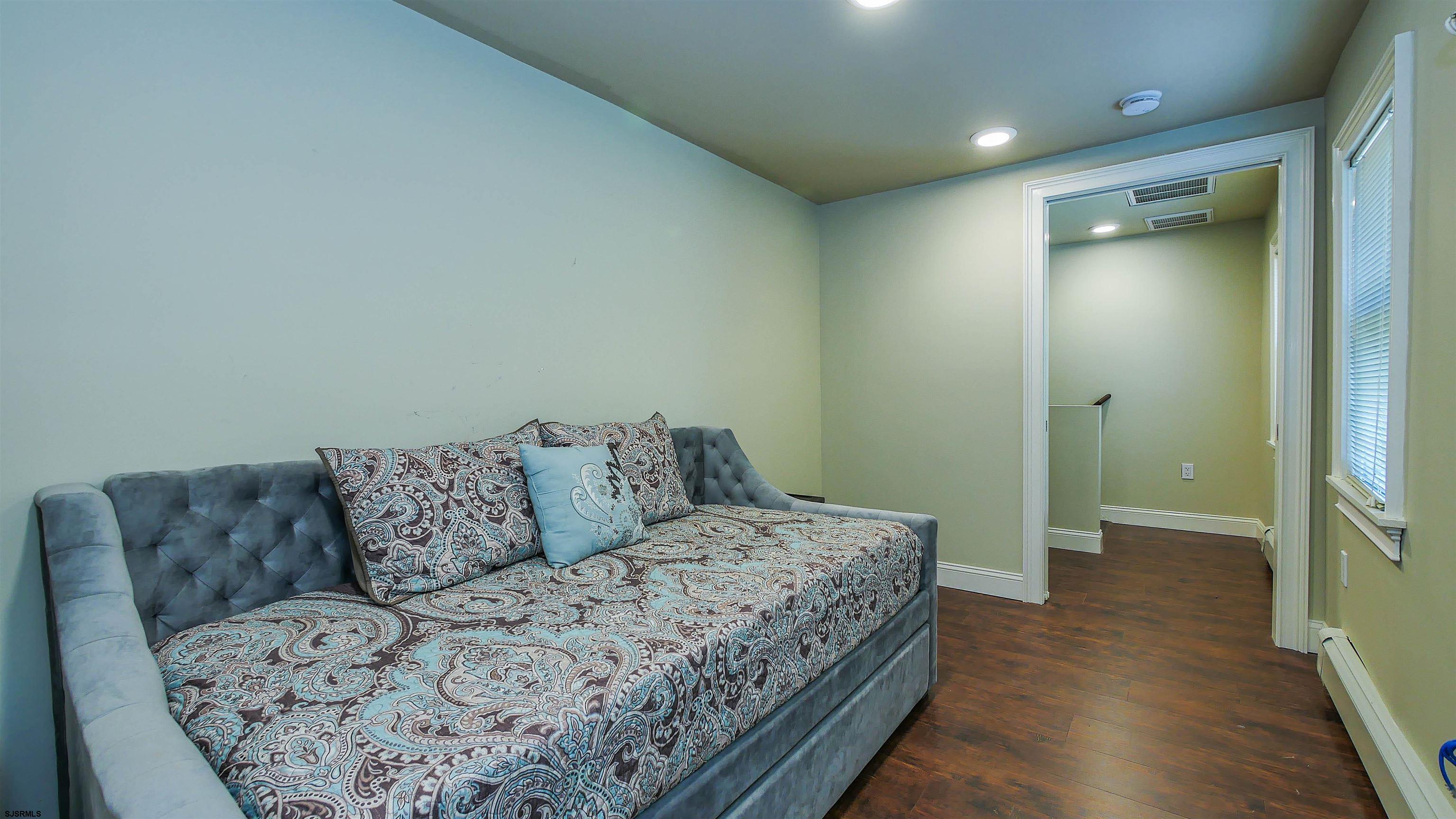 810 East Moss Mill Road Leeds Point, NJ 08205 - Photo 20 of 36 a living room with a couch and a view of en suite bathroom