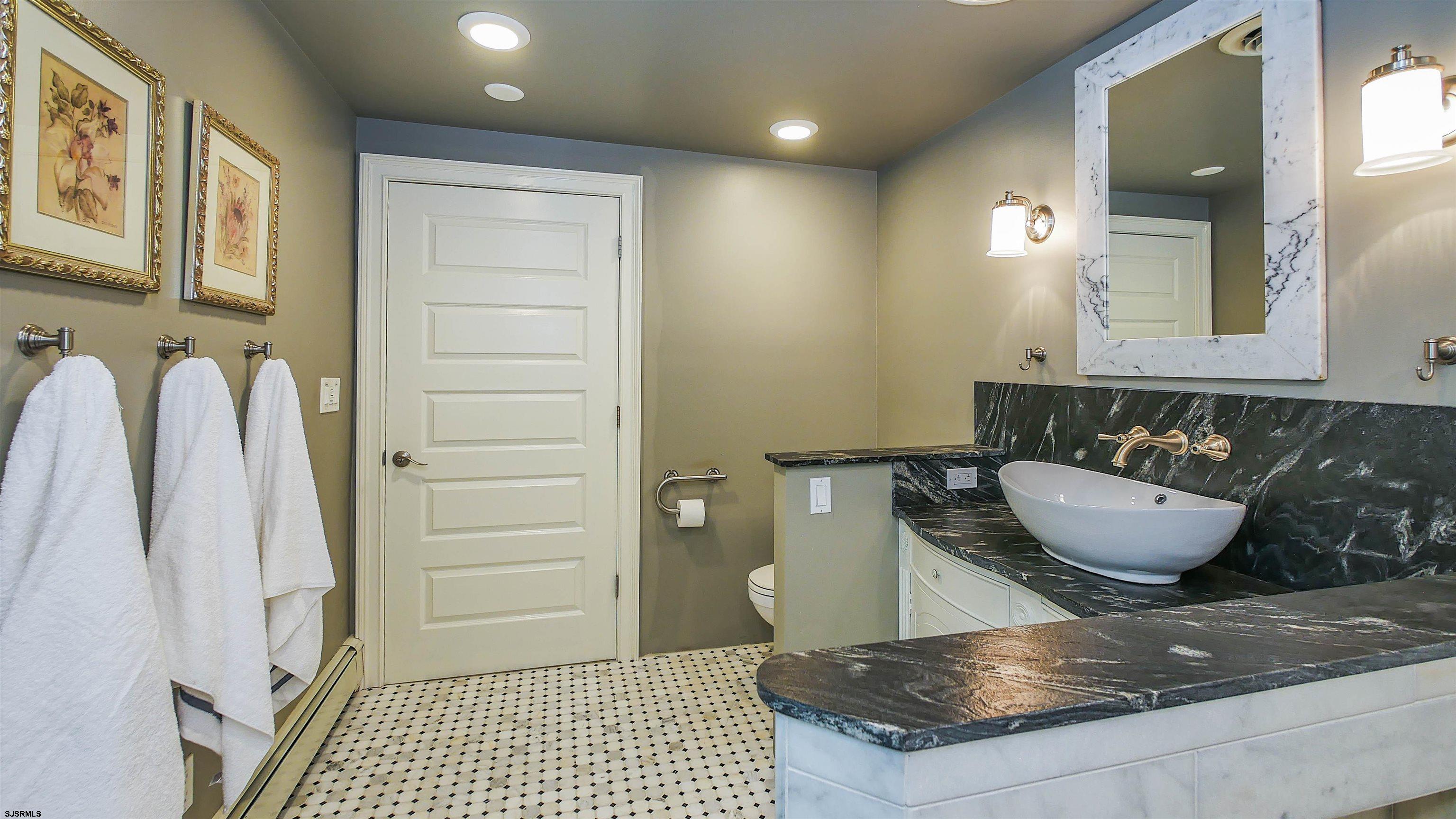 810 East Moss Mill Road Leeds Point, NJ 08205 - Photo 22 of 36 a bathroom with a granite countertop sink a mirror and a shower