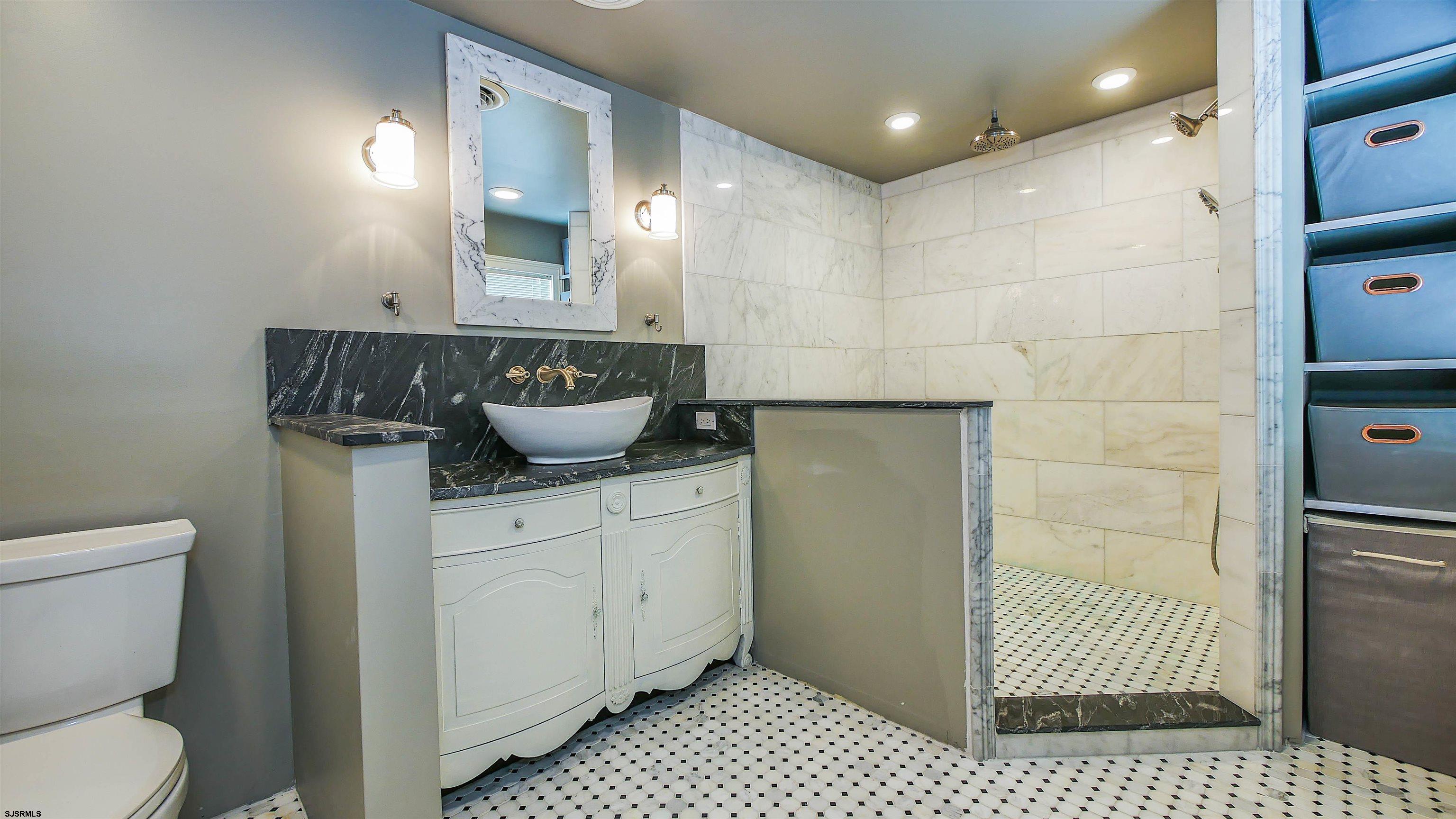 810 East Moss Mill Road Leeds Point, NJ 08205 - Photo 23 of 36 a bathroom with a sink a toilet and shower