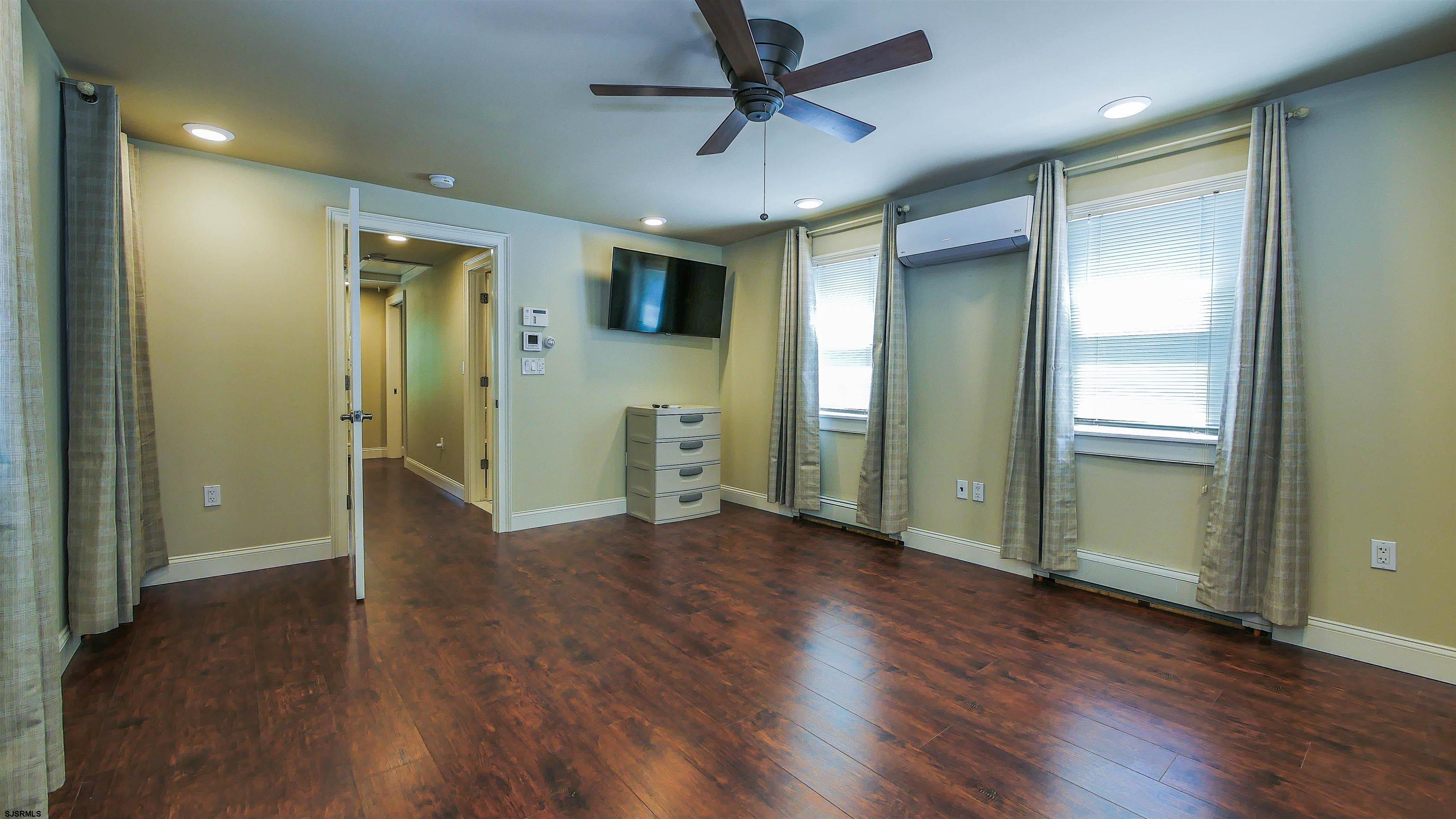 810 East Moss Mill Road Leeds Point, NJ 08205 - Photo 26 of 36 an empty room with wooden floor and a ceiling fan