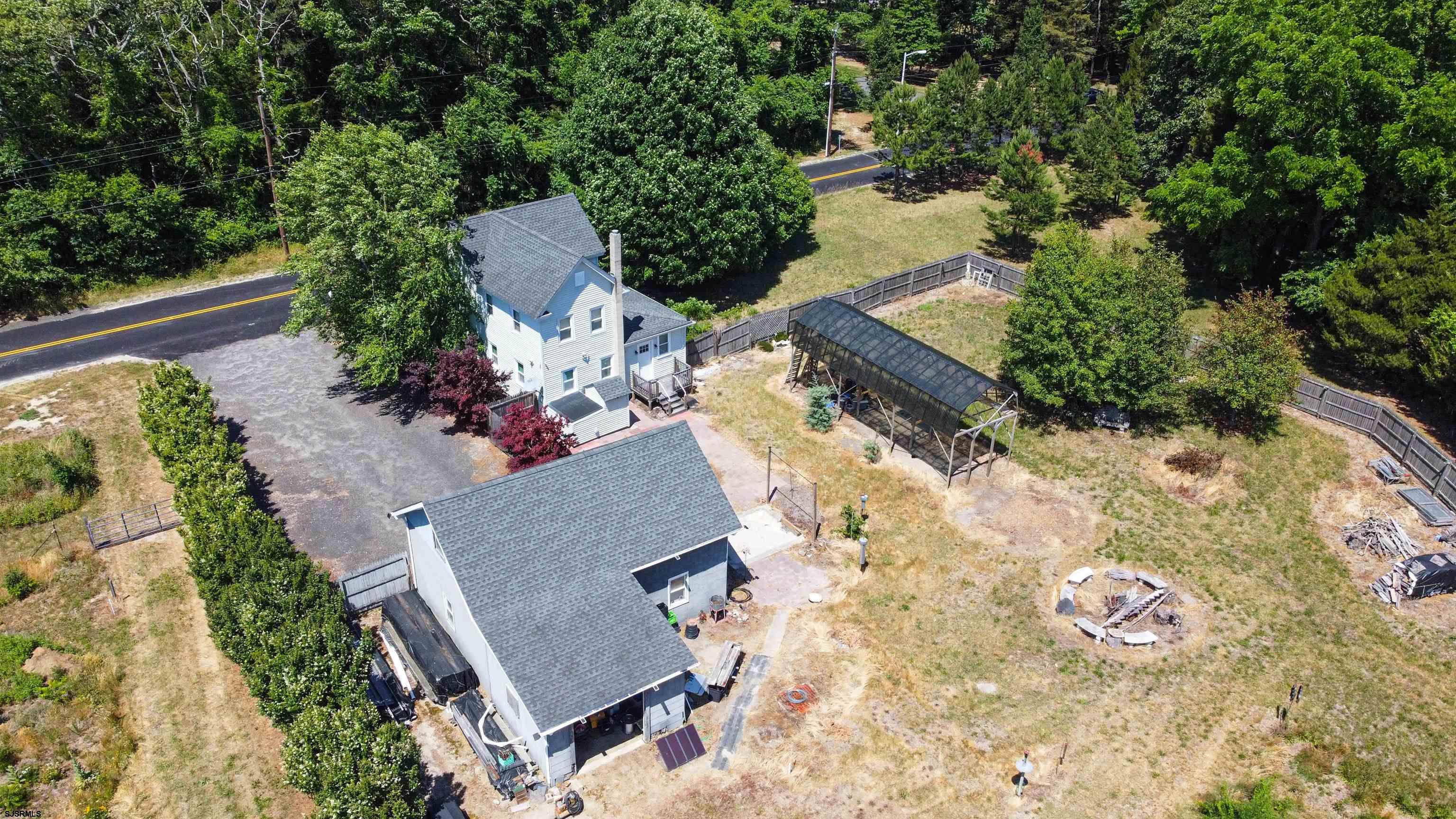 810 East Moss Mill Road Leeds Point, NJ 08205 - Photo 36 of 36 an aerial view of a house with a yard and trees