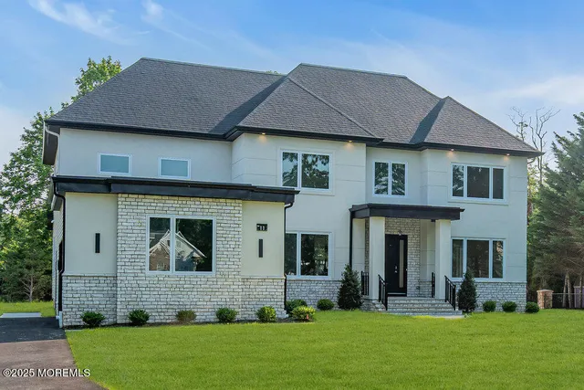 a front view of a house with a garden