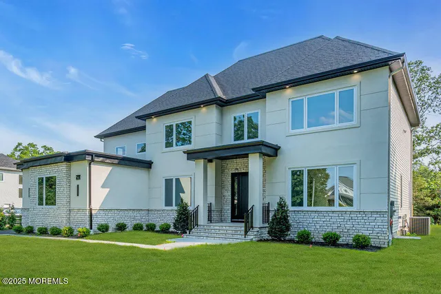 a front view of a house with a garden