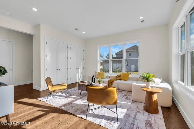 an aerial view of residential houses with outdoor space and trees