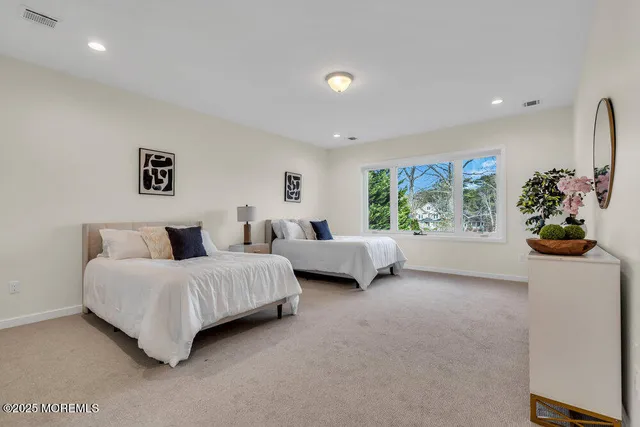 a front view of a house with garden and trees