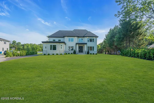 a front view of a house with a garden