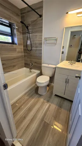 a bathroom with a toilet and a bathtub