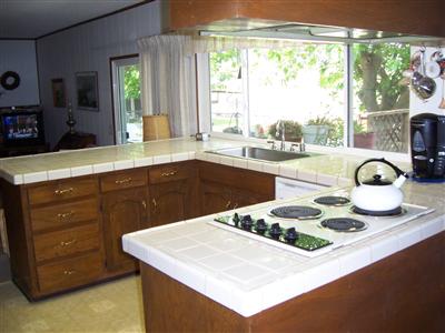 4785 Esquivel Road Vacaville, CA 95688 - Photo 6 of 12 Large kitchen has tons of cabinet and counter space. Big window that looks out to the property. Double oven, wet bar, and trash compactor.