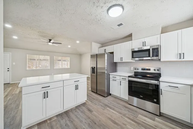 a kitchen with a sink stove and microwave