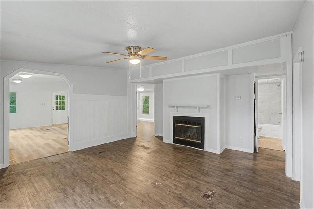 360 Black Knob Church Road Ranger, GA 30734 - Photo 5 of 20 an empty room with wooden floor fireplace and windows