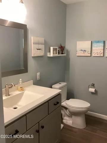 a bathroom with a sink mirror and toilet