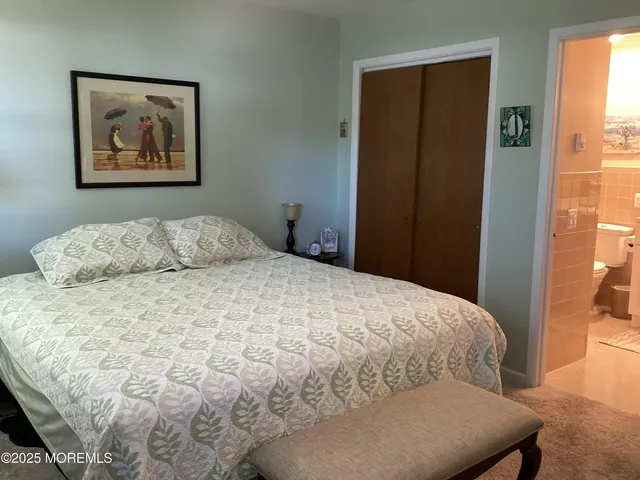 a large bed sitting in a bedroom next to a window