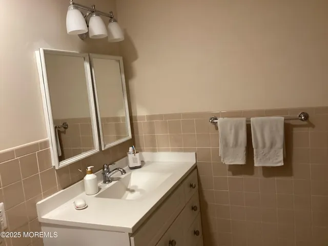 a bathroom with a sink vanity and a mirror