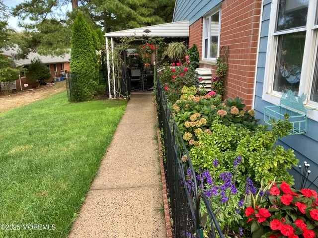 a front view of a house with a yard and fountain in middle