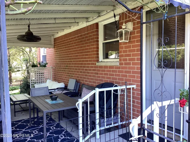 a backyard of a house with table and chairs