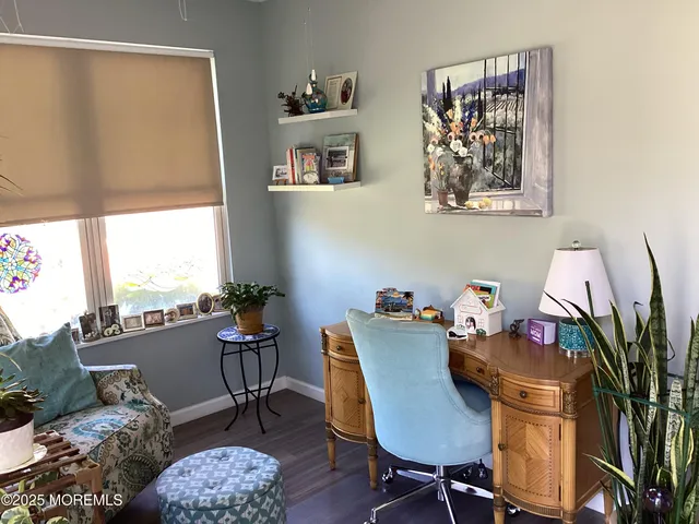 a view of a workspace with furniture and a window