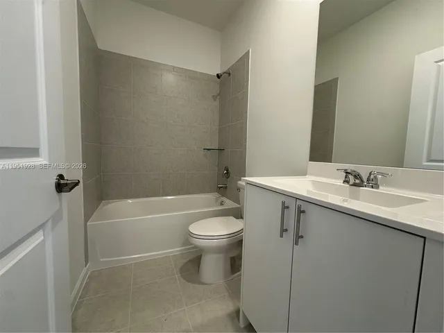 a bathroom with a granite countertop sink toilet and bathtub