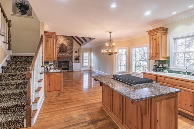 a kitchen with granite countertop a stove and a sink