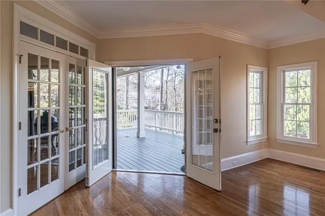 a view of a big room with wooden floor and windows
