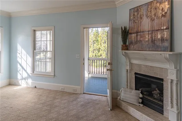 a view of livingroom with furniture a fireplace and windows