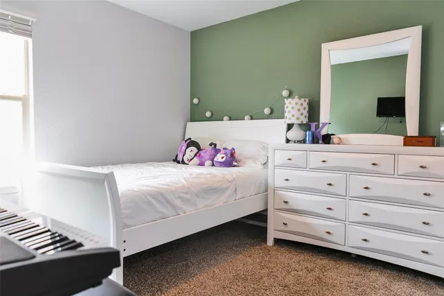 a bedroom with a bed and a dresser