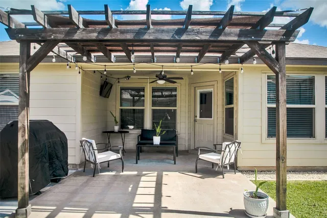 a building outdoor space with patio furniture and potted plants