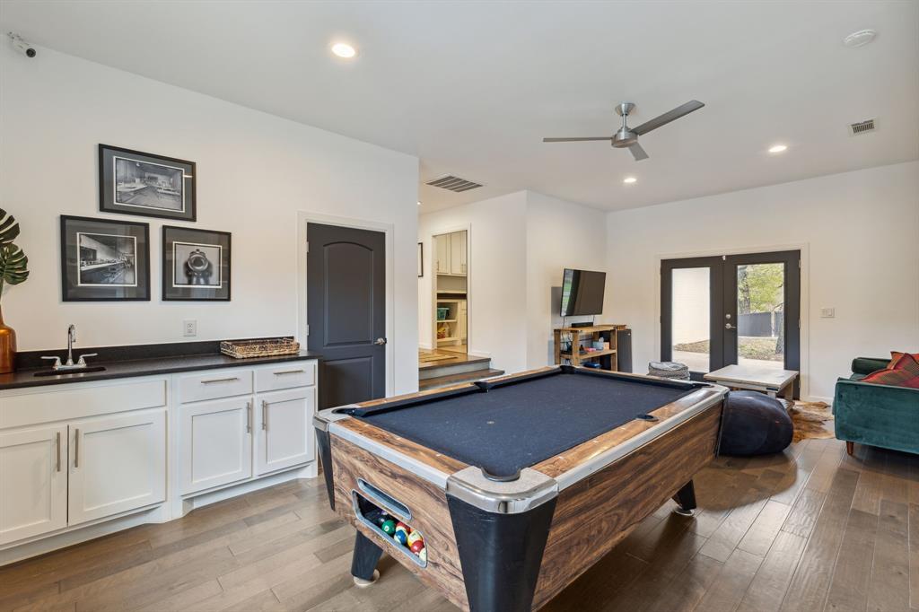 7342 Briar Road Azle, TX 76020 - Photo 21 of 40 Game room features a wet bar, a celing fan and double doors that open into the courtyard