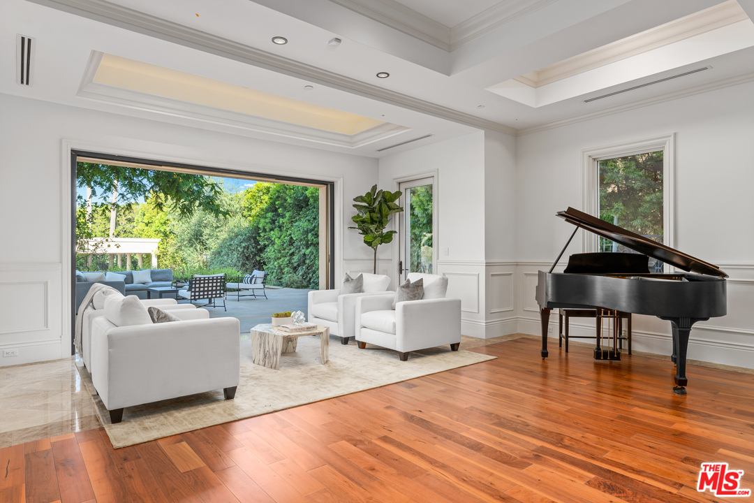210 North Rockingham Avenue Los Angeles, CA 90049 - Photo 11 of 50 a living room with furniture and a wooden floor