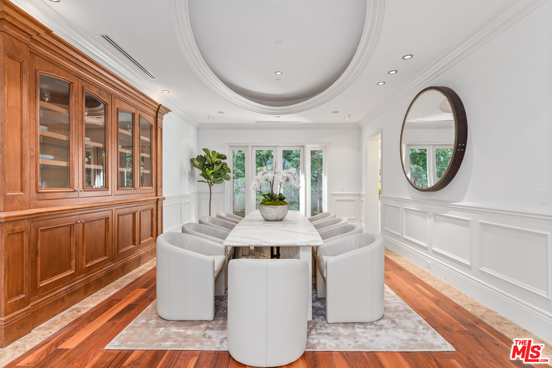 210 North Rockingham Avenue Los Angeles, CA 90049 - Photo 15 of 50 a dining room with chandelier and wooden floor