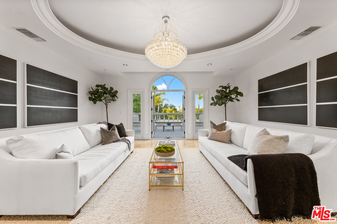 210 North Rockingham Avenue Los Angeles, CA 90049 - Photo 22 of 50 a living room with furniture and a chandelier