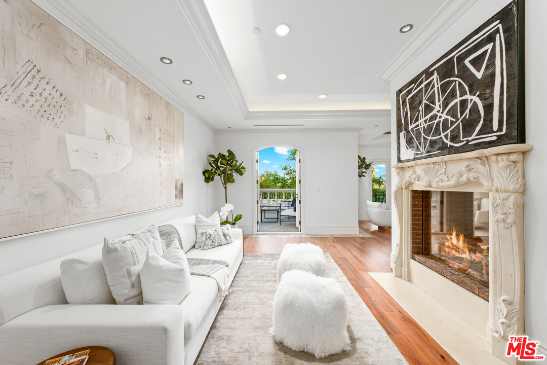 210 North Rockingham Avenue Los Angeles, CA 90049 - Photo 25 of 50 a living room with furniture and a fireplace