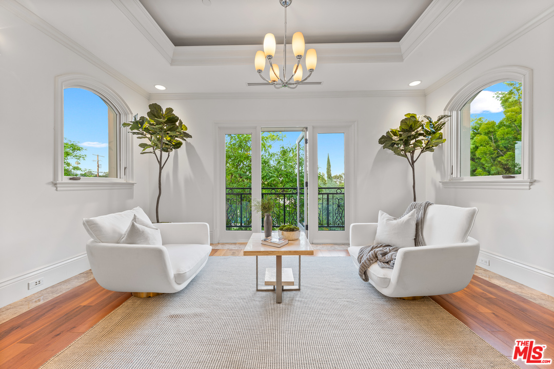 210 North Rockingham Avenue Los Angeles, CA 90049 - Photo 27 of 50 a living room with furniture and a chandelier