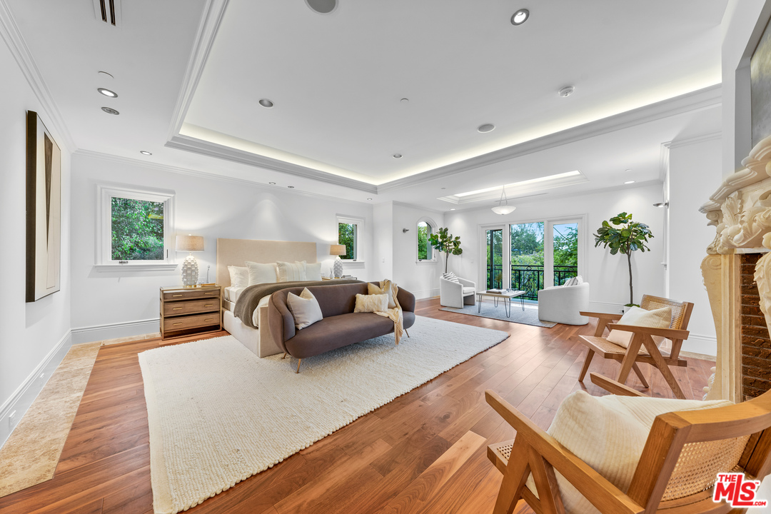 210 North Rockingham Avenue Los Angeles, CA 90049 - Photo 35 of 50 a living room with furniture and a wooden floor