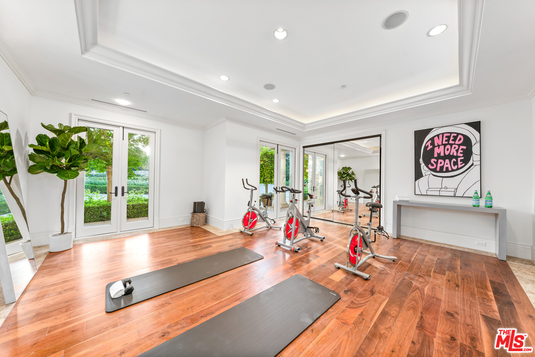 210 North Rockingham Avenue Los Angeles, CA 90049 - Photo 40 of 50 a living room with furniture floor to ceiling window and wooden floor