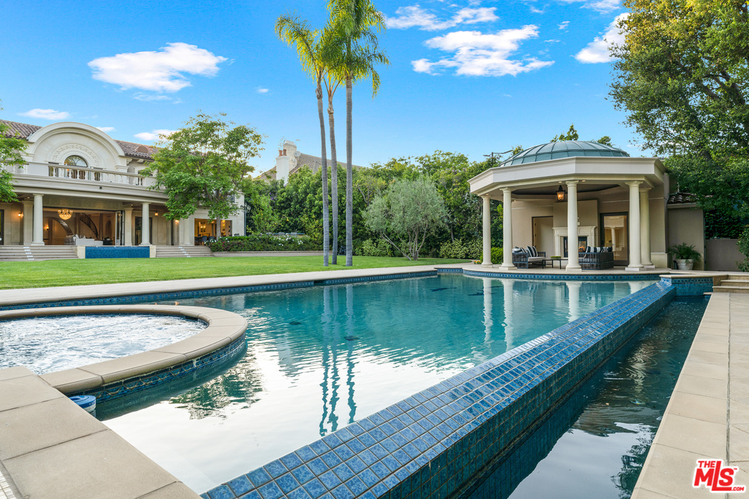 210 North Rockingham Avenue Los Angeles, CA 90049 - Photo 44 of 50 a view of a house with swimming pool and a yard
