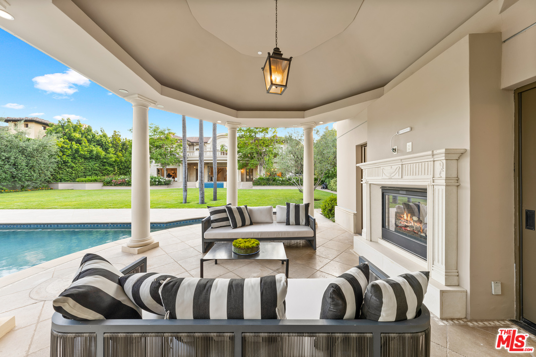 210 North Rockingham Avenue Los Angeles, CA 90049 - Photo 46 of 50 a living room with furniture and a large window