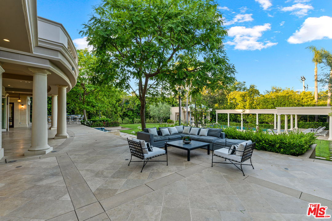 210 North Rockingham Avenue Los Angeles, CA 90049 - Photo 49 of 50 a view of a house with backyard sitting area and garden